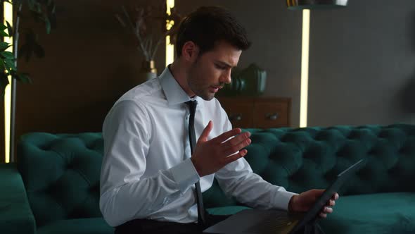 Businessman Working on Laptop in Office, Employee Looking at Graphs on Screen