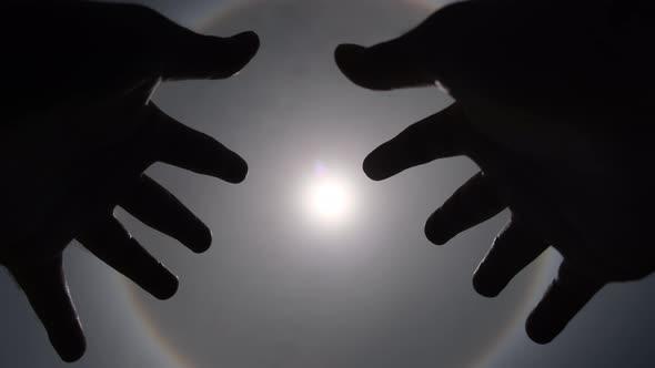 Aerial view of the sun with a circular rainbow surrounded by bright skies.