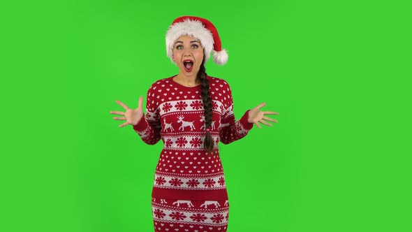 Sweety Girl in Santa Claus Hat with Shocked Surprised Wow Face Expression. Green Screen