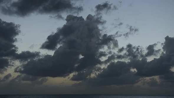Twilight to night time lapse of clouds over sea