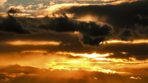 Dramatic Sunset in the Sky Through Orange Layered Cumulus Clouds Timelapse