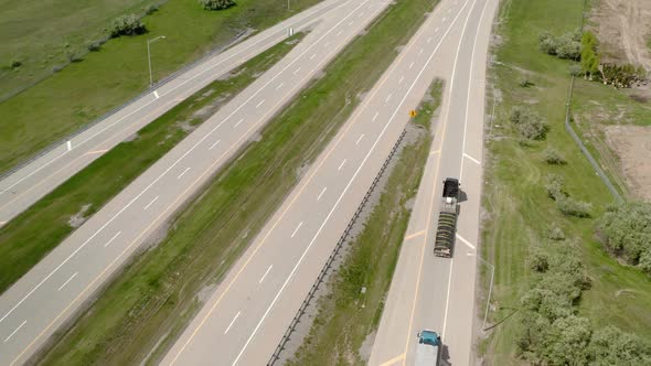 Aerial Drone Shot of Truck Rides on Road That Turns