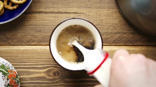 Pouring Stream Milk From Bottle To the Cup of Americano