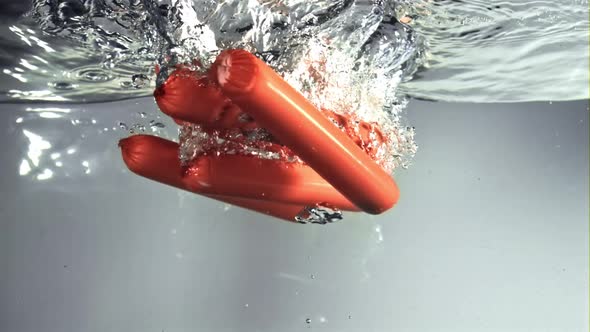 Sausages Fall Under the Water with Air Bubbles