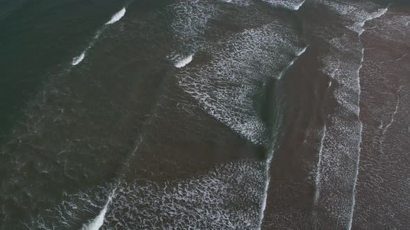 Top View Of Foamy Waves At Scarborough North Bay Beach In North Yorkshire, England UK. Aerial Shot