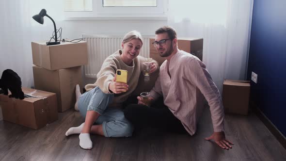 Happy Couple Relaxes After Moving in a New Home