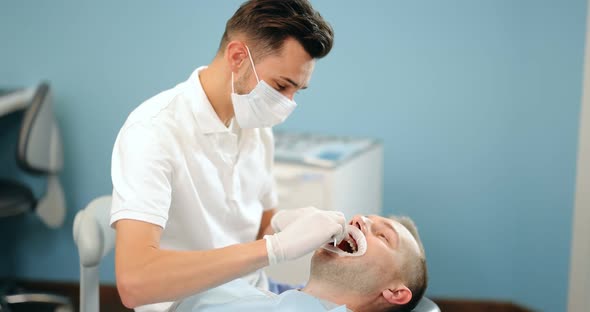 Dentist and Patient During an Orthodontic Treatment