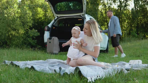 A Happy Family is Resting Outside the City and Traveling By Car