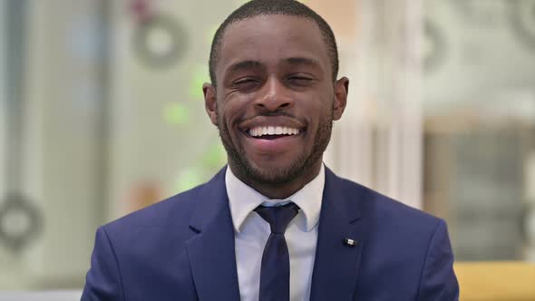 Portrait of Cheerful African Businessman Smiling at the Camera