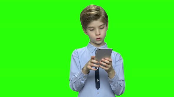 Portrait of Boy with Smartphone Texting or Playing