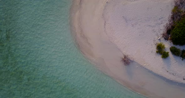 Natural drone clean view of a sandy white paradise beach and blue ocean background in colorful 4K