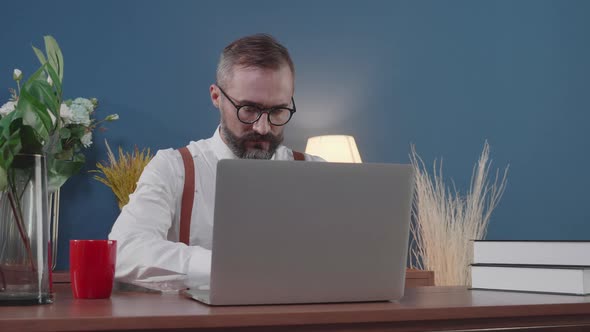 Senior american business man freelancer using laptop computer at home office.