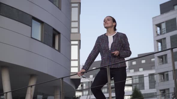 Businesswoman climbing up street stairs