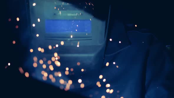 Man Uses Welding Machine While Wearing a Hardhat.