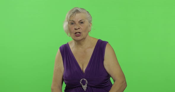 An Elderly Woman Quarrels at Someone. Old Grandmother. Chroma Key