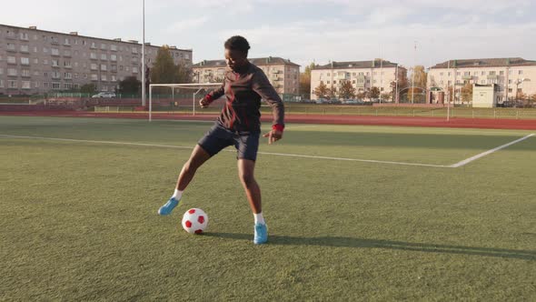 Young Black Girl Training at the City Stadium and Practicing Ball Possession Technique Soccer