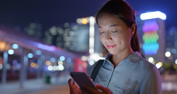 Woman use of mobile phone online at night