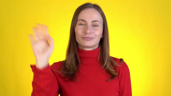 Smiling Woman Isolated on Yellow Background in Studio