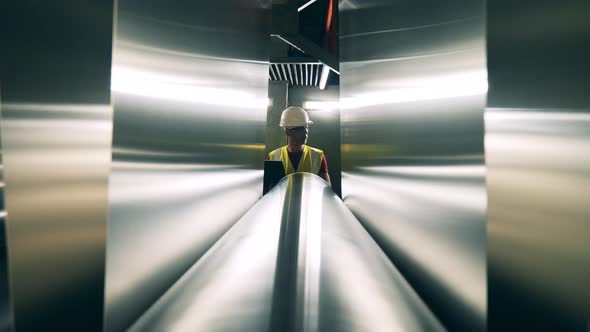 Engineer Small Figure Behind Huge Rolling Mill