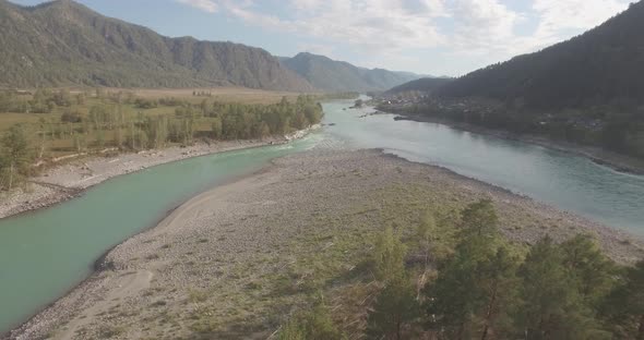 Low Altitude Flight Over Fresh Fast Mountain River with Rocks at Sunny Summer Morning.