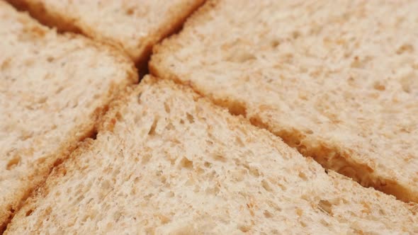 Fresh toast bread whole grain baked surface close-up slow tilt 4K 2160p 30fps UltraHD footage - Text