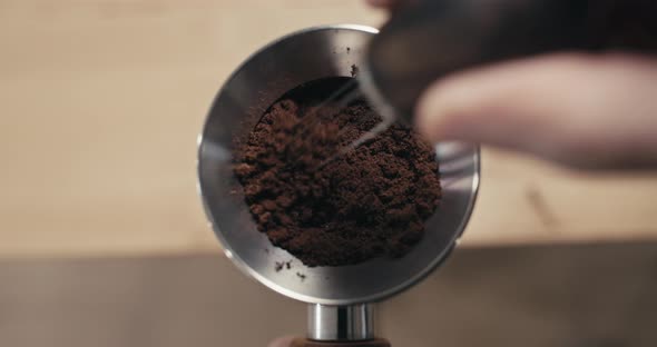 Espresso Coffee Grinds Preparation with WDT Tool, Closeup of Weiss Distribution Technique in Slow Mo