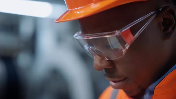 Portrait Engineer in Safety Glasses at Machinery Plant