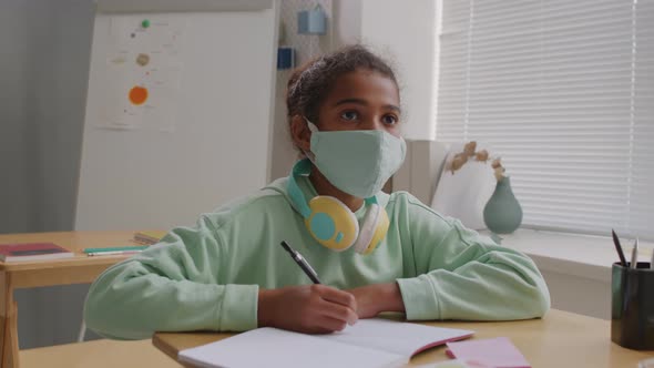 African-American 11-Year-Old Girl in Face Mask in Class