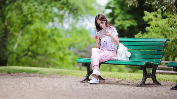 Happy Young Woman with a City Map in Europe, Travel Tourist Woman with Map in Park Outdoors During