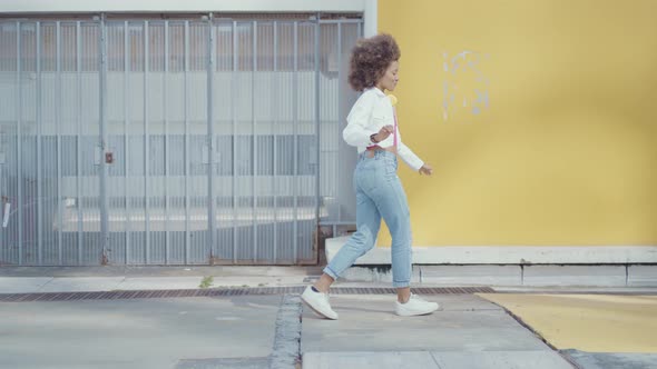 Beautiful young woman with curly hairstyle and fashionable clothes