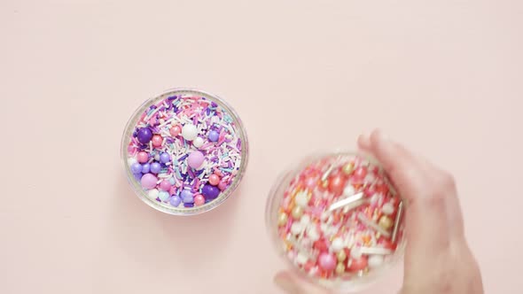 Colorful purple sprinkle blend on a pink background