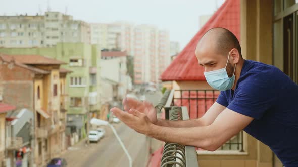 Man on Balcony Clapping in Support for Doctors
