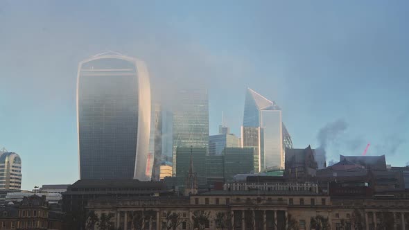 Skyscrapers in City of London in mist in the business area showing Walkie Talkie building and other 