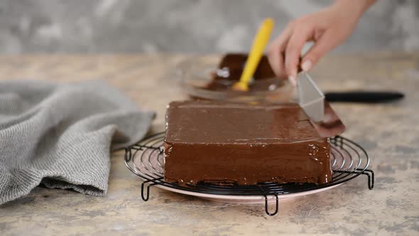 The Confectioner Glazes a Cake.