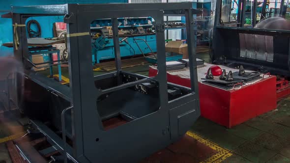 Conveyor Assembly Stage the Body of Tractor at Big Industrial Factory Timelapse