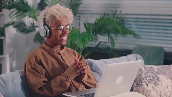 African Woman with Laptop Wear Headphones Having Pleasant Remote Conversation