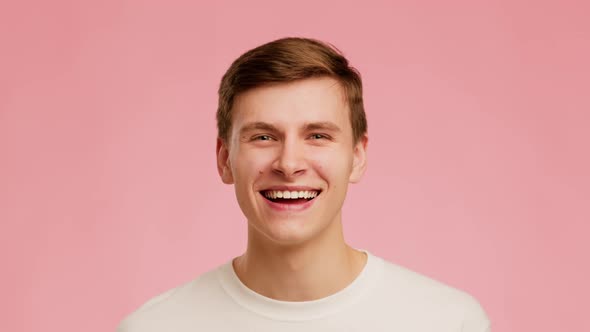 Millennial Guy Laughing Out Loud Having Fun Over Pink Background