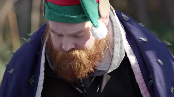 Bearded homeless man eating bread