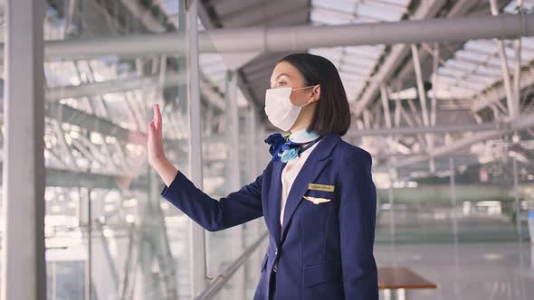 Airliner air hostess crew wear face mask walking in airport terminal to the airplanel during Covid19