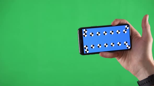 Closeup Footage of a Smartphone in Horizontal Orientation with Tracking Points and Man Sliding Pages