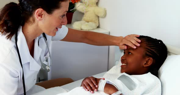 Female doctor examining a sick girl