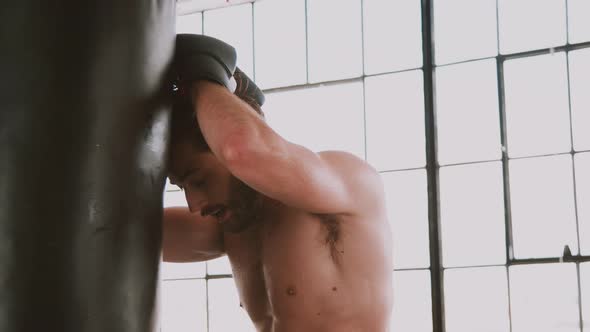 Athletic Man Punching A Punching Bag