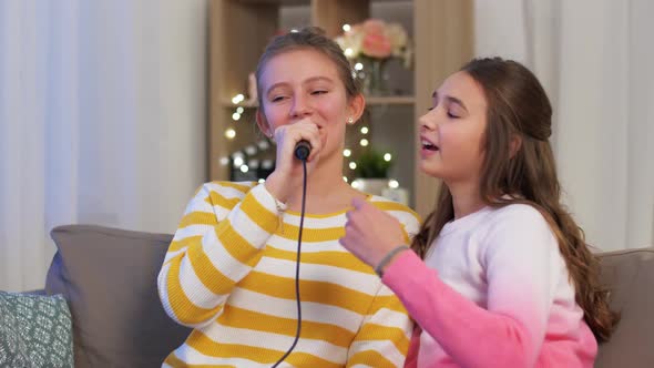 Teenage Girls with Microphone Singing at Home