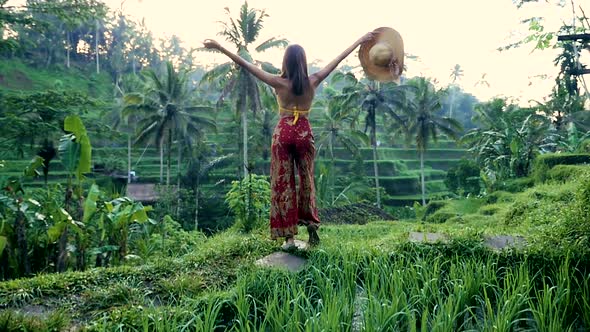 Beautiful girl spending time in the rice fields of Bali