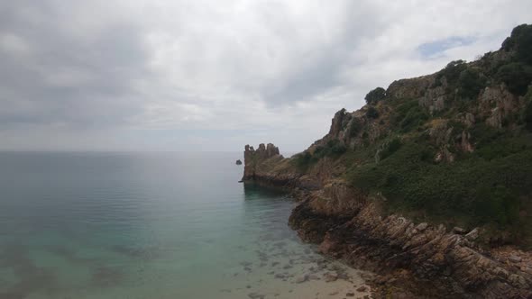 Drone aerial footage of the rocky cliffs of Beauport Beach in Jersey.