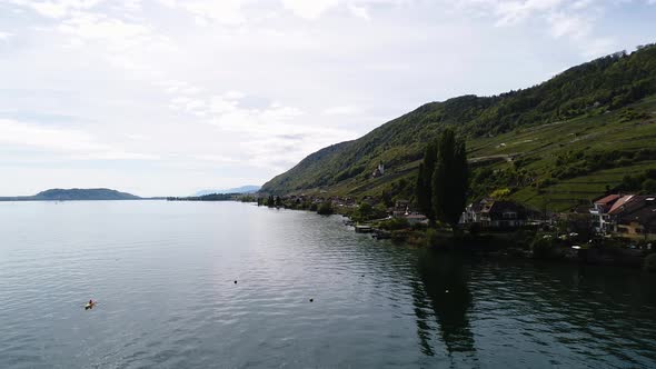 aerial view of lake with vine yard and a canoe in the water, flying slow switzerland biel