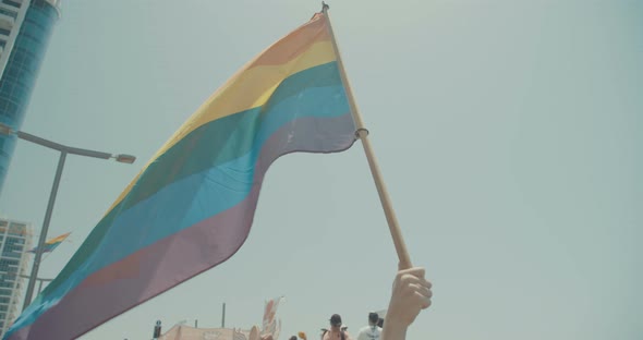 Slow motion of the pride flag waving during a pride parade