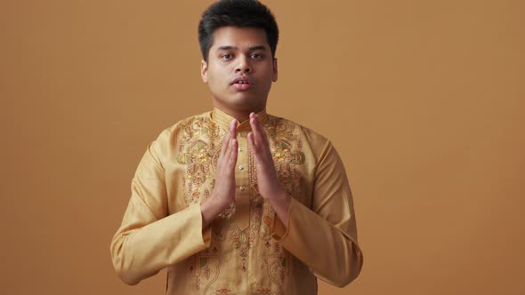 Handsome Indian man in national cloth doing meditation