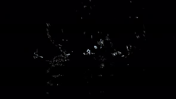 Large Drops of Rain Fall on the Black Water Forming Rippling Surface of the Water. Black Background
