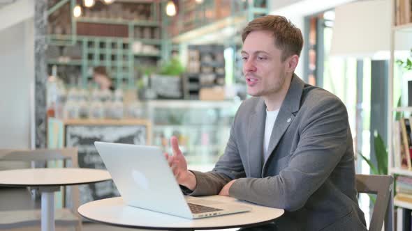 Young Man Talking on Video Call on Laptop